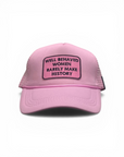 Pink cap with text patch on a white background