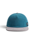 THE SEA HORSE teal corduroy baseball cap with a grey brim and a seahorse logo patch on the side.